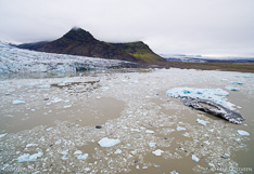 Floating icebergs in Fjallsárlón glacier lake in front of the Fjallsjökull glacier tongue in Iceland. Aerial photo captured with a camera drone (Phantom) by Paul Oostveen.