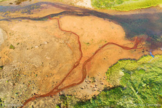 Small river from above in Hraundalur in the Westfjords of Iceland. Aerial photo captured by drone.