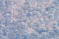 Snow and ice on a frozen lake in Iceland. Aerial photo captured with a camera drone (Phantom) by Paul Oostveen.