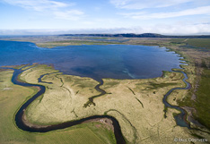 River flows into the lake Sigriðarstaðavatn at the coast of Vatsnes in northern Iceland. Aerial photo captured with a camera drone (Phantom).