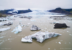 Floating icebergs in Fjallsárlón glacier lake in front of the Fjallsjökull glacier tongue in Iceland. Aerial photo captured with a camera drone (Phantom) by Paul Oostveen.