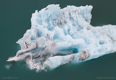 Ice falling off a floating iceberg in Jökulsárlón glacier lagoon in Iceland. Aerial photo captured with a camera drone (Phantom) by Paul Oostveen.