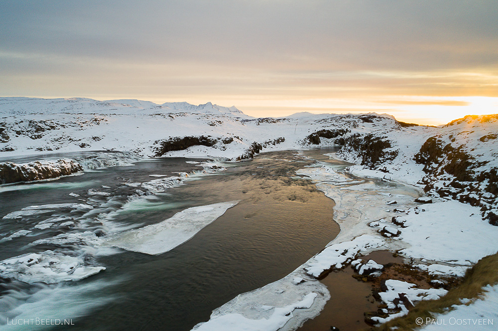 Sunset above Tröllafossar waterfalls in Iceland in the winter. Long exposure aerial photo captured with a camera drone (Phantom) with aid of a ND16 filter. Tröllafossar means waterfalls of the trolls. Photographer: Paul Oostveen.