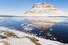 Snow-covered Kirkjufell in winter with reflection. Aerial photo captured with a camera drone by Paul Oostveen.